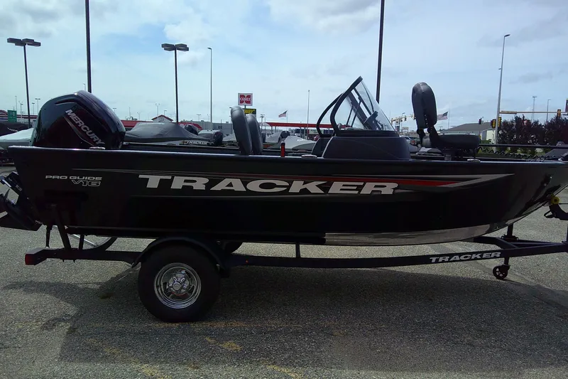 Slide: The Image of 2026 Tracker Pro Guide V-16 WT boat on trailer in parking lot. - 4