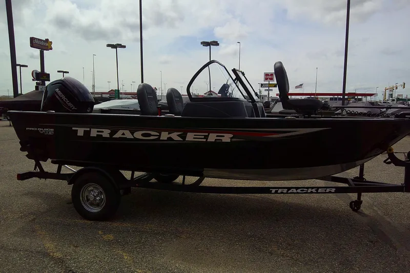 Slide: The Image of 2026 Tracker Pro Guide V-16 WT boat on trailer in parking lot. - 5