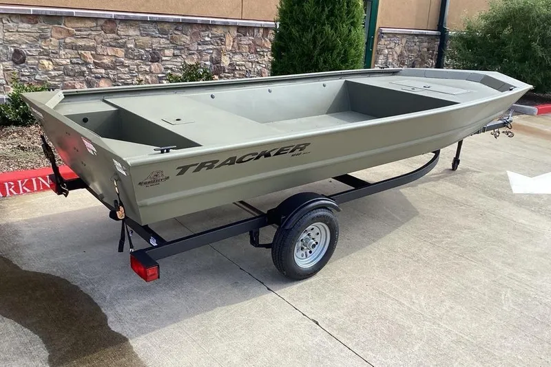 Slide: The Image of 2026 Tracker Grizzly 1648 Utility boat on trailer, parked on concrete surface. - 3