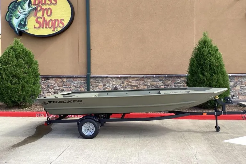 Slide: The Image of 2026 Tracker Grizzly 1648 Utility boat on trailer outside Bass Pro Shops. - 4