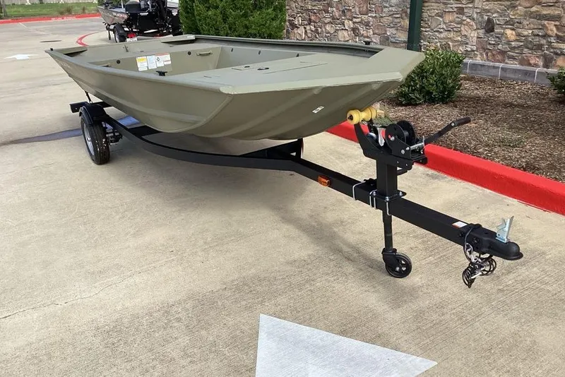 Slide: The Image of 2026 Tracker Grizzly 1648 Utility boat on trailer, parked on concrete surface. - 5
