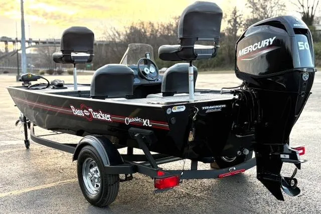 Slide: The Image of 2026 Tracker Bass Tracker Classic XL boat with Mercury 50 engine, parked outdoors. - 77