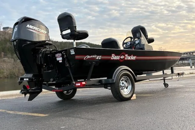 Slide: The Image of 2026 Tracker Bass Tracker Classic XL boat on trailer, parked by a scenic waterfront. - 79