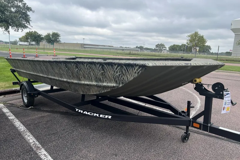 The Image of 2026 Tracker Grizzly 2072 Utility boat on trailer, parked outdoors. - 0