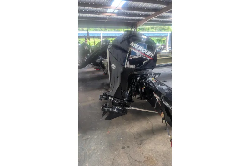 Slide: The Image of 2026 Tracker Pro Team 175 Crappie Edition with Mercury outboard motor in a covered area. - 4