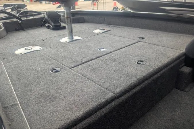 Slide: The Image of 2026 Tracker Pro Team 175 Crappie Edition boat deck with carpeted storage compartments. - 9