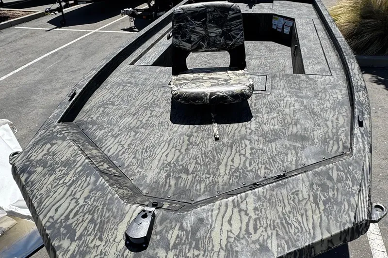 Slide: The Image of 2026 Tracker Grizzly 1654 T Sportsman boat with camouflage design and swivel seat. - 3