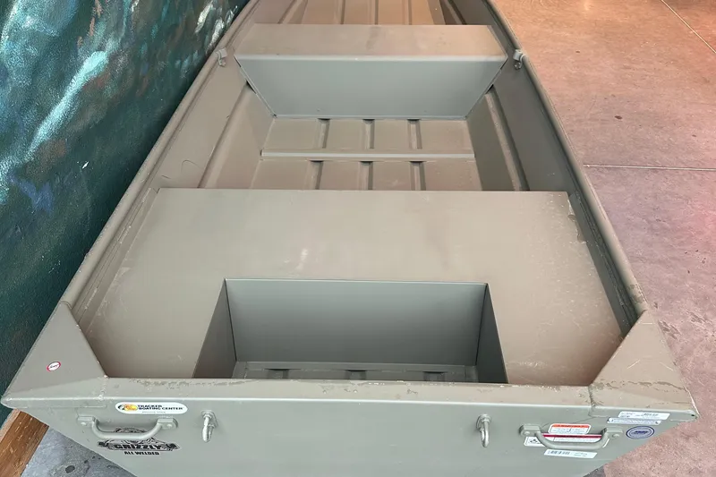 Slide: The Image of 2026 Tracker Grizzly 14 Jon boat, interior view, showcasing seating and storage compartments. - 2