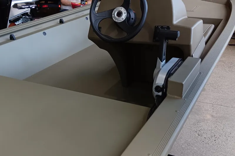 Slide: The Image of 2026 Tracker Grizzly 1648 SC boat with Mercury engine, displayed outdoors. - 3