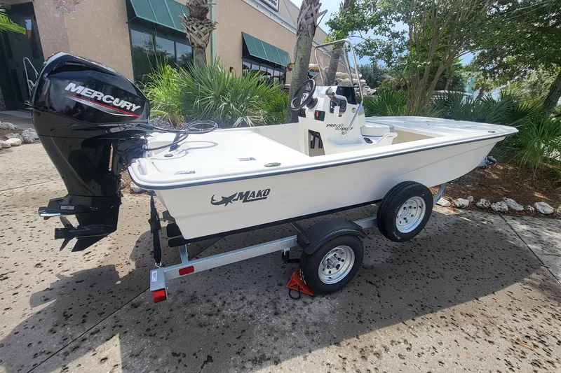 The Image of 2026 Mako Pro Skiff 13 CC boat on trailer in parking lot. - 0