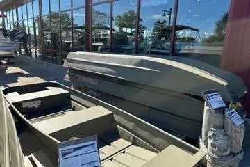 The Image of 2026 Tracker Grizzly 12 Jon boats displayed outside a showroom. - 0