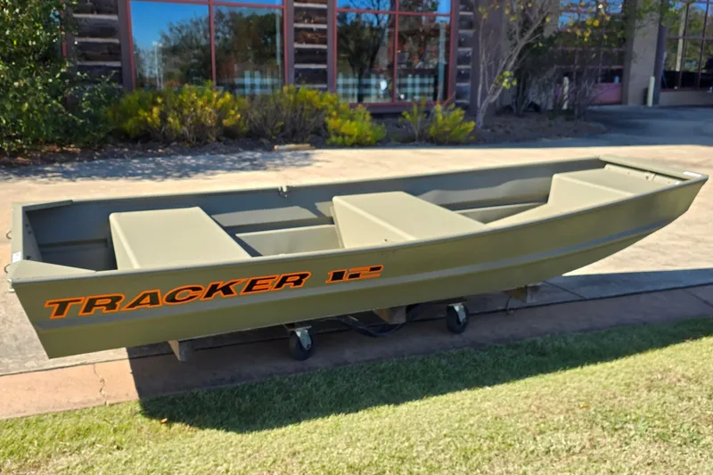 The Image of 2026 Tracker Grizzly 12 Jon boat displayed outdoors on a sunny day. - 0