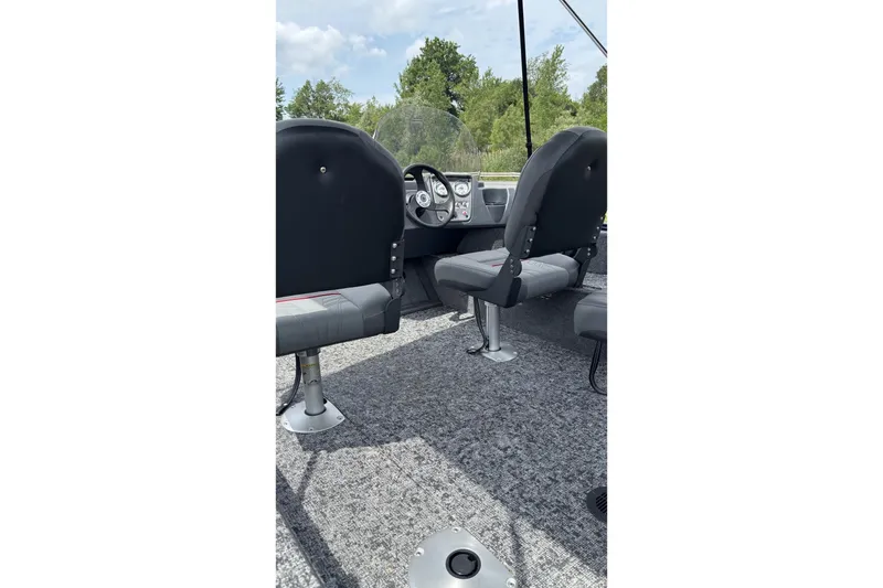 Slide: The Image of Interior of 2026 Tracker Pro Guide V-16 SC boat with seating and steering console. - 3