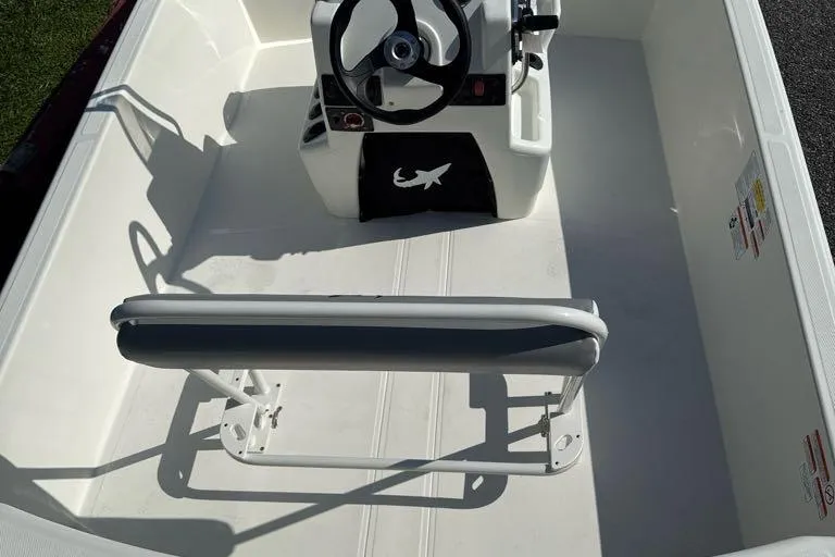 Slide: The Image of 2026 Mako Pro Skiff 17 CC interior with steering console and seating. - 3