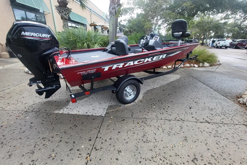 The Image of 2026 Tracker Pro Team 175 boat with Mercury engine, parked outdoors on a trailer. - 0