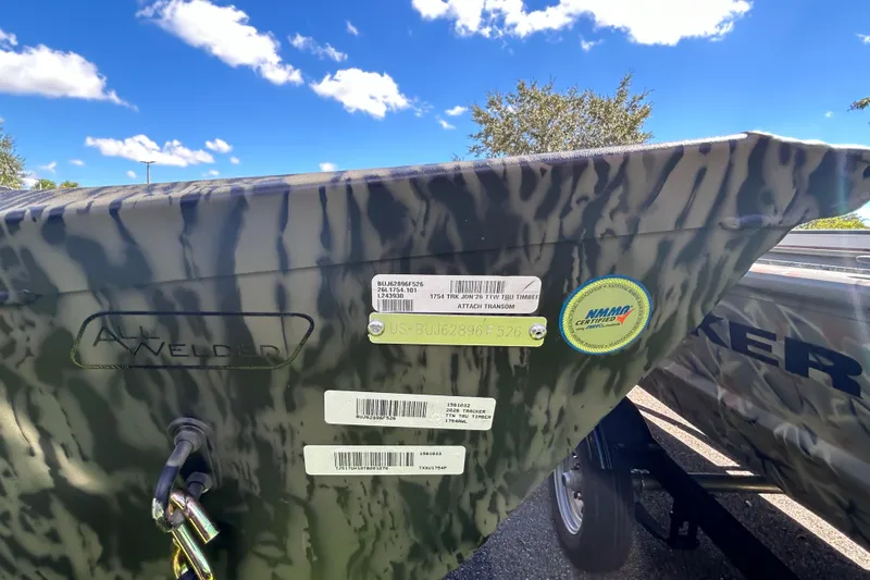 Slide: The Image of 2026 Tracker Grizzly 1754 Utility boat with camouflage pattern and certification stickers. - 3