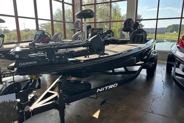Slide: The Image of 2026 Nitro Z20 XL Pro fishing boat displayed indoors with Garmin equipment. - 2