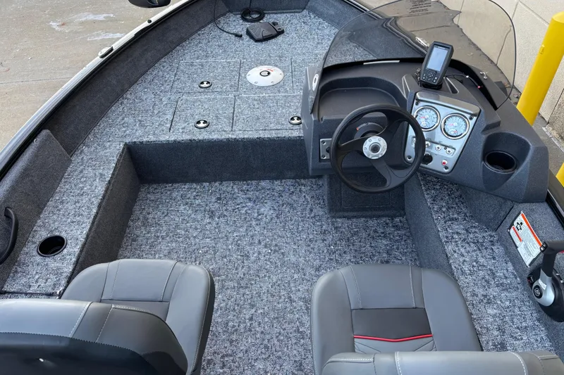 Slide: The Image of 2026 Tracker Pro Guide V-16 SC boat interior with steering console and seating. - 78