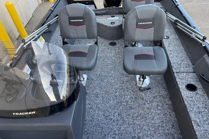 Slide: The Image of 2026 Tracker Pro Guide V-16 SC boat interior with two gray seats and steering console. - 79