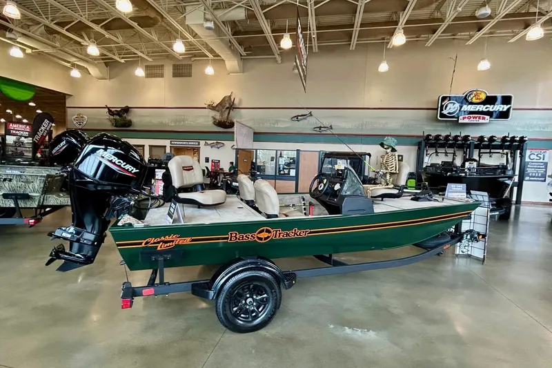 Slide: The Image of 2026 Tracker Bass Tracker Classic Limited boat displayed in showroom with Mercury engine. - 3