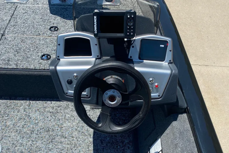 Slide: The Image of 2026 Tracker Pro Team 175 Crappie Edition boat dashboard with steering wheel and electronics. - 5