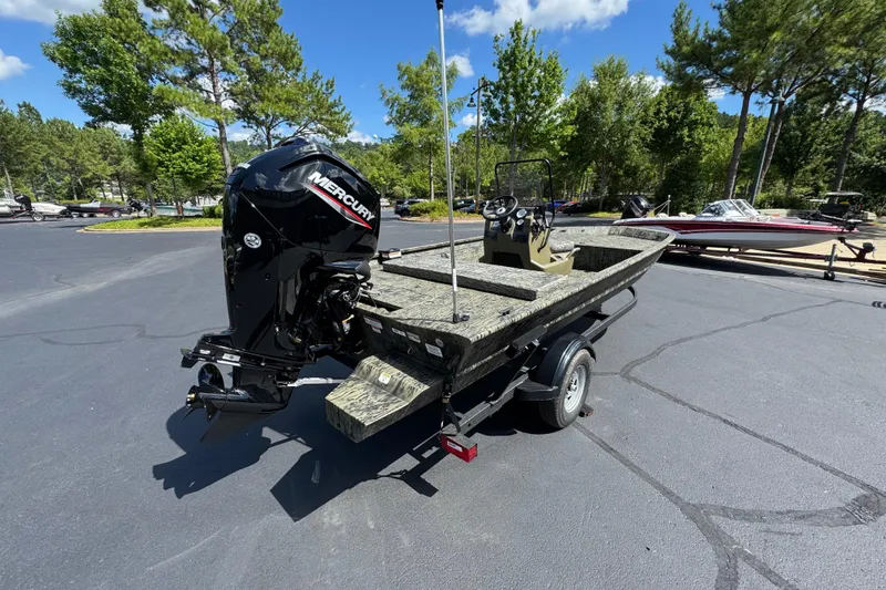 Slide: The Image of 2026 Tracker Grizzly 1654 T Sportsman boat on trailer, featuring Mercury outboard motor. - 2