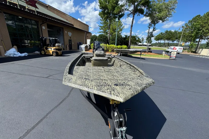 Slide: The Image of 2026 Tracker Grizzly 1654 T Sportsman boat parked outdoors on a sunny day. - 3