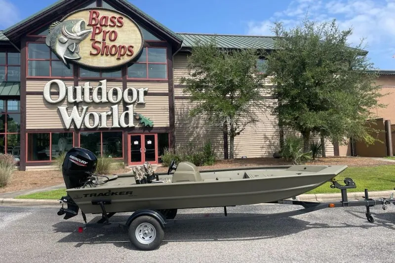 Slide: The Image of 2026 Tracker Grizzly 1754 SC boat on trailer outside Bass Pro Shops Outdoor World. - 4