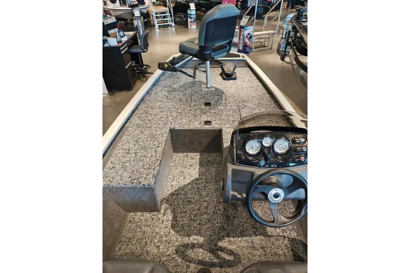 Slide: The Image of 2026 Tracker Pro 170 boat interior with steering console and seating in showroom. - 10
