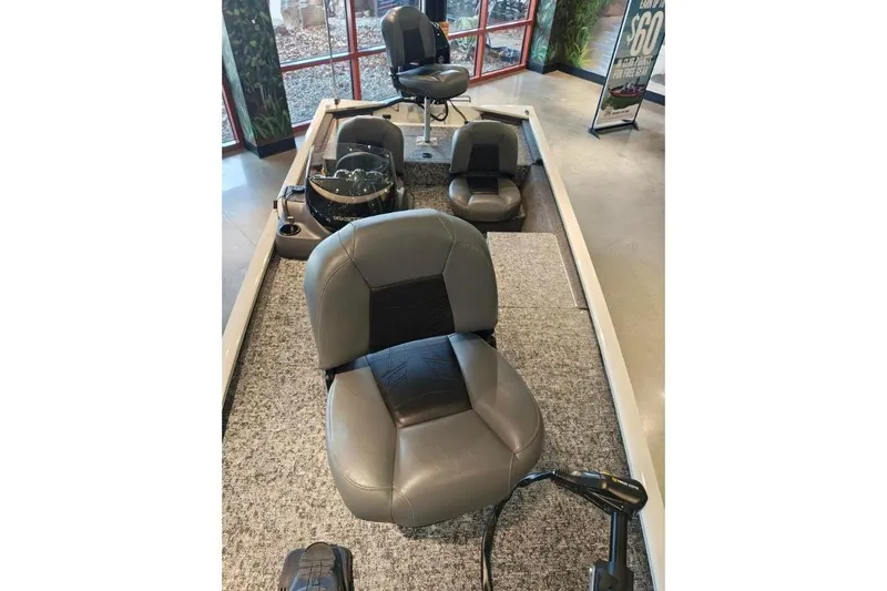 Slide: The Image of 2026 Tracker Pro 170 boat interior with gray seating and carpeted flooring. - 9