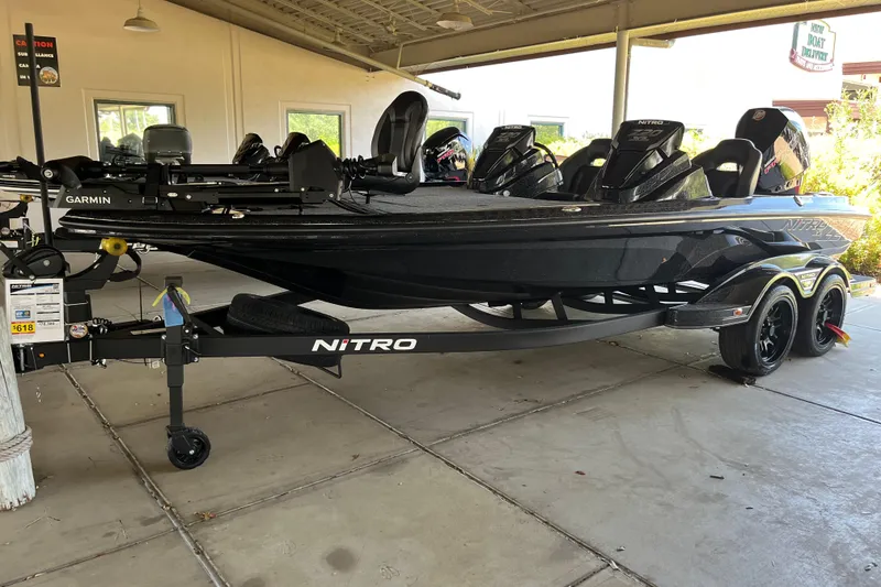 The Image of 2026 Nitro Z20 XL Pro boat on trailer, featuring Garmin equipment, parked under a shelter. - 0