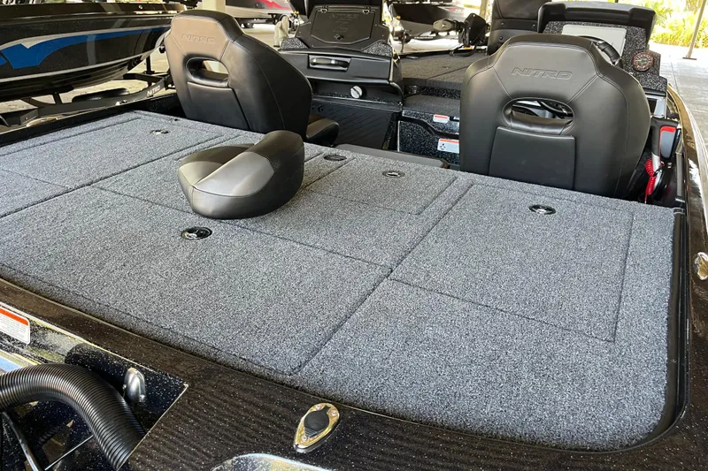 Slide: The Image of 2026 Nitro Z20 XL Pro boat interior with gray carpet and black seats. - 7