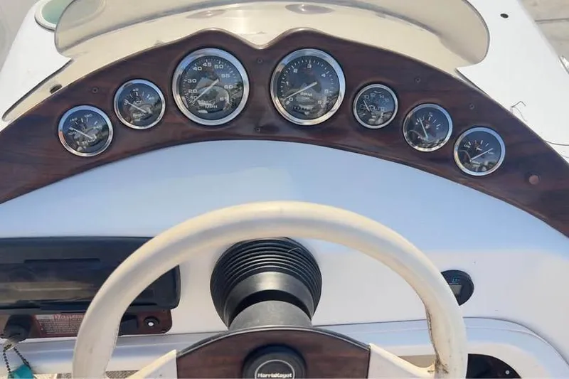 Slide: The Image of Dashboard of a 2001 Harris-Kayot Star 20V boat with gauges and steering wheel. - 10