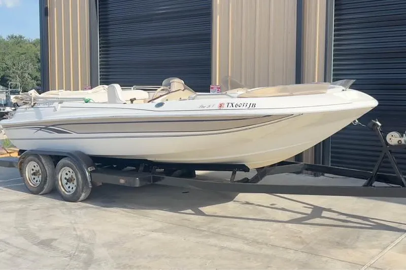 Slide: The Image of 2001 Harris-Kayot Star 20V boat on trailer, parked outside a building. - 2