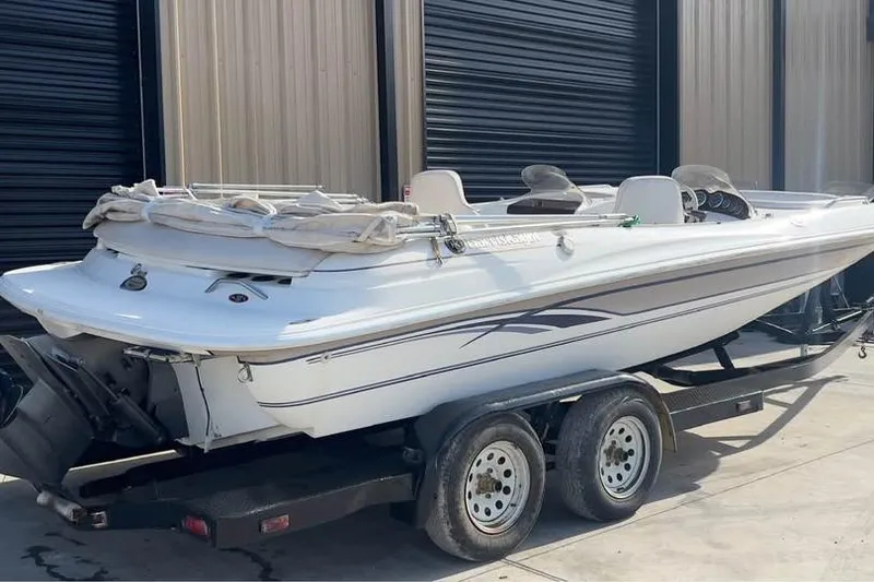 Slide: The Image of 2001 Harris-Kayot Star 20V boat on trailer, parked near industrial building. - 3