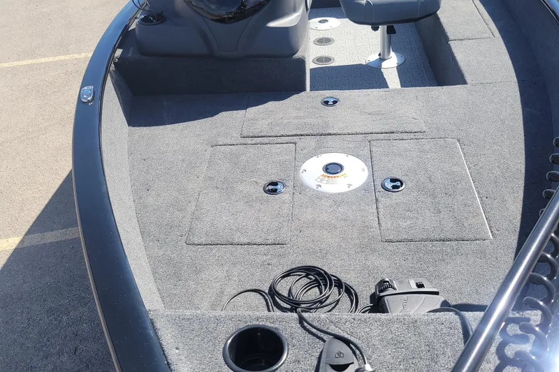 Slide: The Image of 2026 Tracker Super Guide V-16 SC boat interior with carpeted deck and seating. - 3