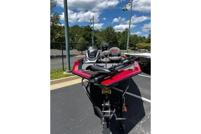 The Image of 2026 Tracker Pro Team 175 Crappie Edition boat in parking lot under blue sky. - 0