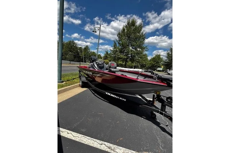 Slide: The Image of 2026 Tracker Pro Team 175 Crappie Edition boat on trailer, parked outdoors under blue sky. - 2