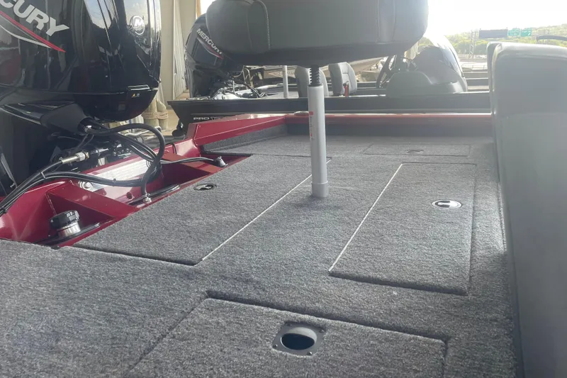 Slide: The Image of 2026 Tracker Pro Team 175 boat interior with carpeted deck and Mercury engine. - 5