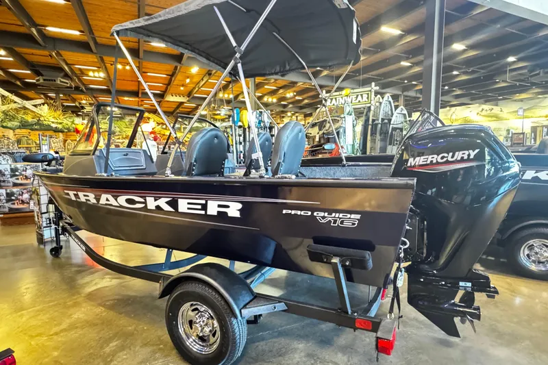 The Image of 2026 Tracker Pro Guide V-16 WT boat with Mercury engine displayed indoors. - 0
