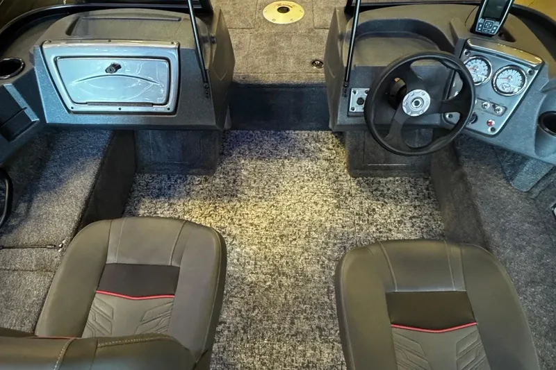 Slide: The Image of 2026 Tracker Pro Guide V-16 WT boat interior with steering wheel and seating. - 3