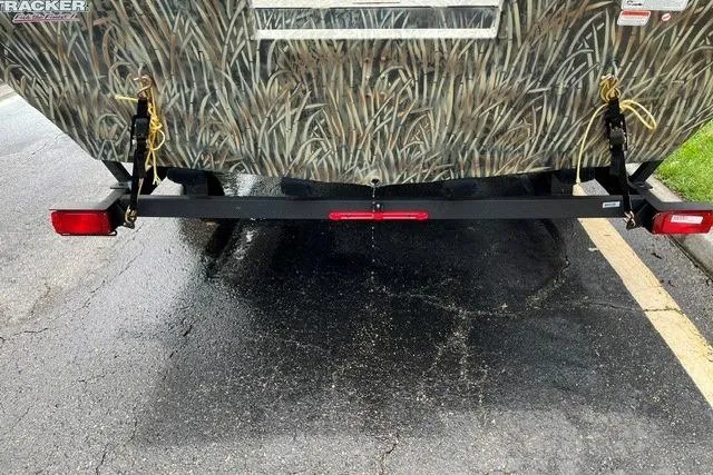 Slide: The Image of 2026 Tracker Grizzly 2072 Utility boat with camouflage design and trailer hitch. - 2