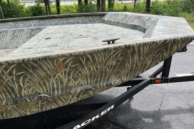 Slide: The Image of 2026 Tracker Grizzly 2072 Utility boat with camouflage design on a trailer. - 4