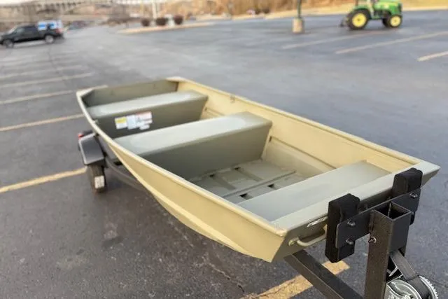 Slide: The Image of 2026 Tracker Grizzly 12 Jon boat on trailer in parking lot. - 1