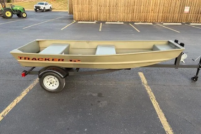 Slide: The Image of 2026 Tracker Grizzly 12 Jon boat on trailer in parking lot. - 3