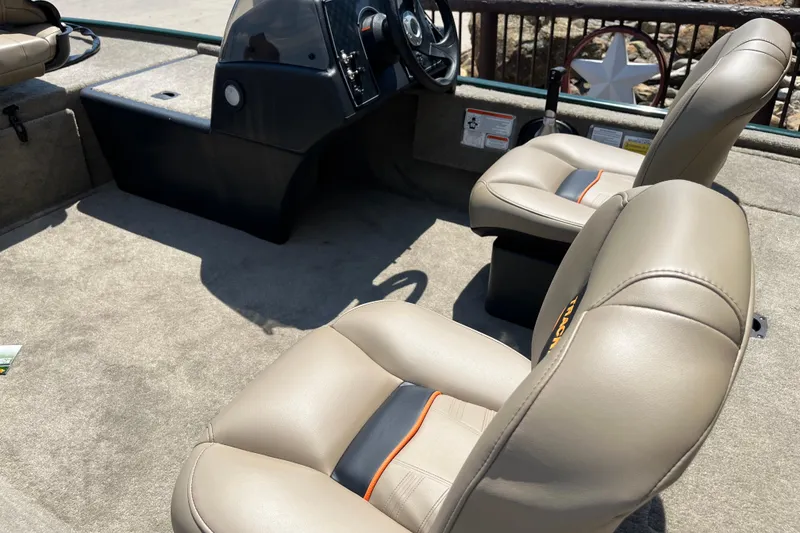 Slide: The Image of 2026 Tracker Bass Tracker Classic Limited boat interior with beige seats and steering console. - 4