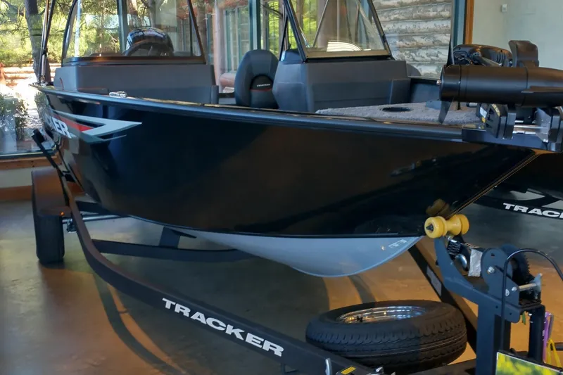 The Image of 2026 Tracker Pro Guide V-175 WT boat on trailer in showroom. - 0