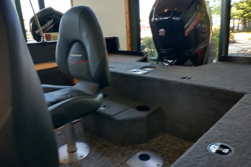 Slide: The Image of Interior of 2026 Tracker Pro Guide V-175 WT boat with steering wheel and seats. - 3