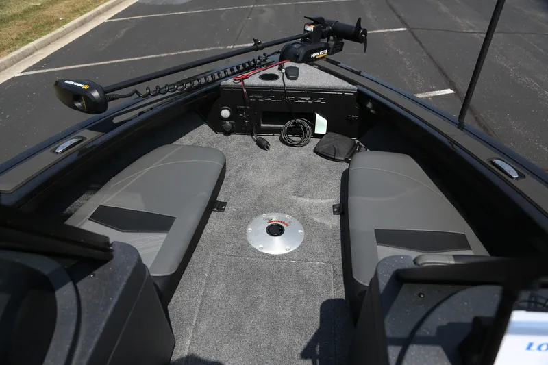 Slide: The Image of 2026 Tracker Targa V-18 Combo boat interior with gray seating and fishing equipment. - 2