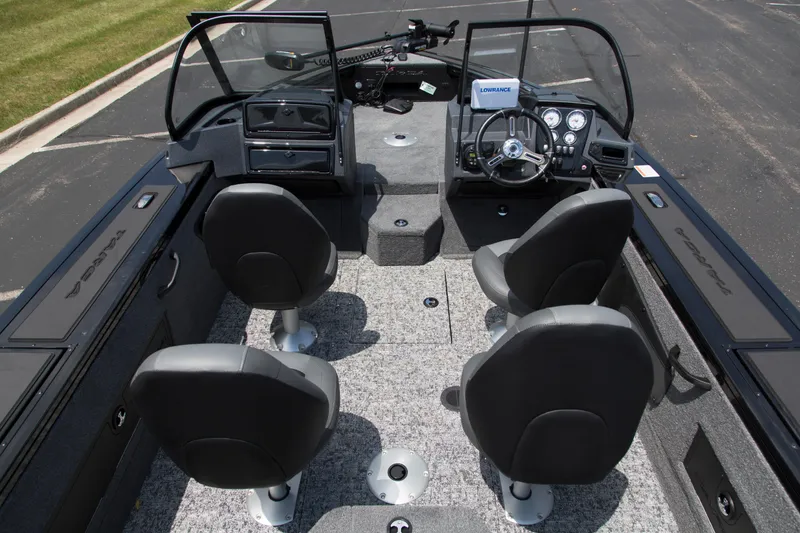 Slide: The Image of 2026 Tracker Targa V-18 Combo boat interior with four seats and steering console. - 5